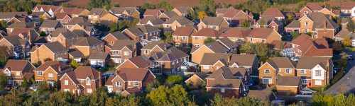 Modern, red brick houses viewed from above.